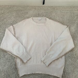 Cream sweater with brown stitching material